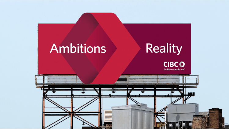 A CIBC billboard with the words "Ambitions" and "Reality," showcasing the bank's branding message.